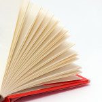 Red hardcover book with flipping pages